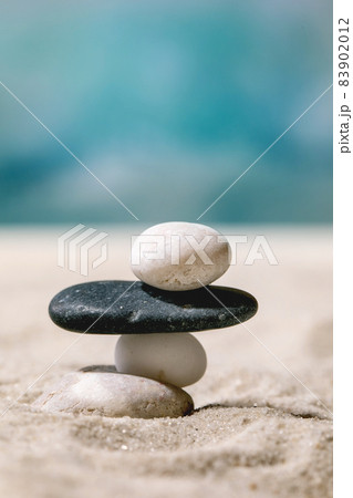 Summer sand sea beach with waves and stones 83902012