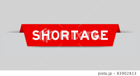 Red color inserted label with word shortage on gray background 83902813