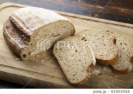 Sliced bread on a cutting board. 83903008