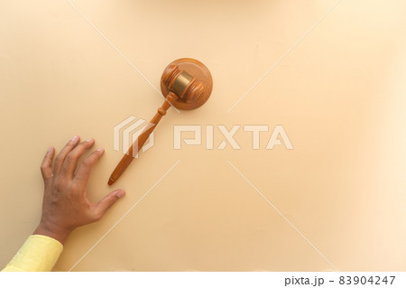close up of person's hand striking the gavel. close up of person's hand striking the gavel. 83904247