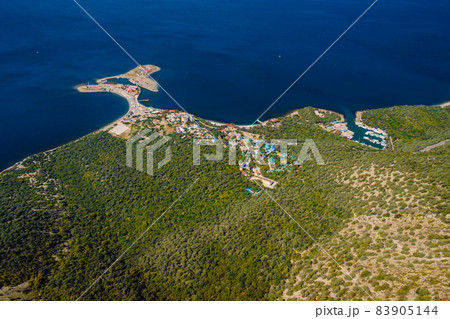 Aerial view of sea coastline with village and mediterranean forest. Aerial view of sea coastline with village and mediterranean forest. 83905144