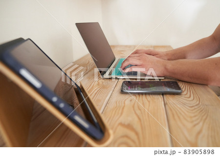 Close-up of a man's hands typing on a keyboard, looking for information. A freelance copywriter is working on a project. The concept of remote work. High quality photo 83905898
