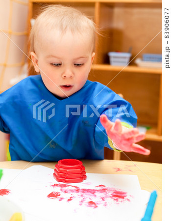 Child painting with hand 83906077