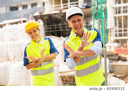 Builders dancing at construction site Builders dancing at construction site 83906332