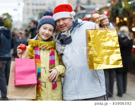 Happy family after shopping on Christmas market Happy family after shopping on Christmas market 83906392