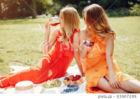 Elegant and stylish girls in a summer park Elegant and stylish girls in a summer park 83907299