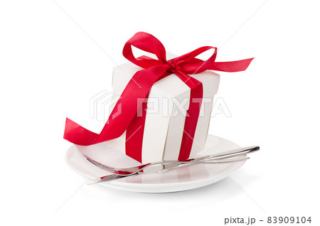 Gift box with red ribbon on plate Gift box with red ribbon on plate 83909104