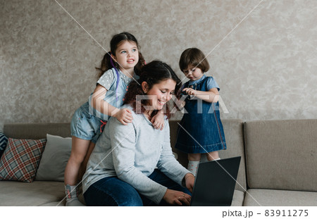 small children prevent their mother from working on the computer small children prevent their mother from working on the computer 83911275