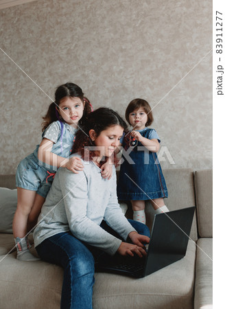 small children prevent their mother from working on the computer small children prevent their mother from working on the computer 83911277