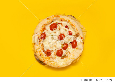 Appetizing homemade pizza Margarita with cheese and tomatoes on a yellow background with copyspace 83911779