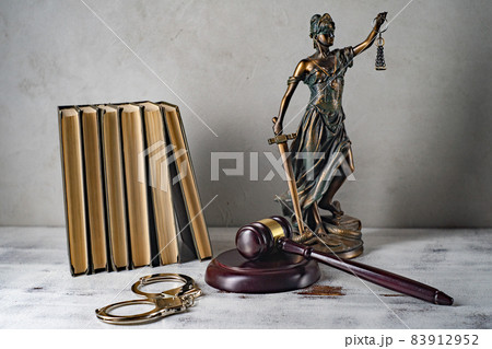 Lady Justice, Judge's gavel, books, handcuffs on an old wooden table Lady Justice, Judge's gavel, books, handcuffs on an old wooden table 83912952