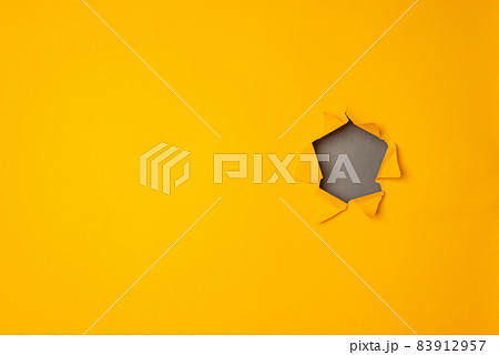 Big paper torn hole in yellow background with copy space. Big paper torn hole in yellow background with copy space. 83912957