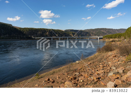 Long concrete bridge over the river on massive pillars. Long concrete bridge over the river on massive pillars. 83913022
