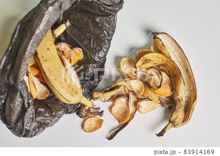 Banana peels in trash can. Using banana peels in compost. Banana skin in recycling bio bin in the kitchen Banana peels in trash can. Using banana peels in compost. Banana skin in recycling bio bin in the kitchen 83914169