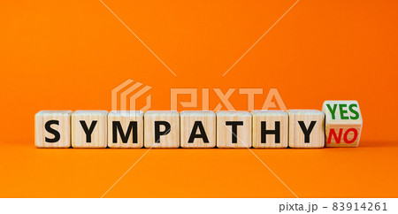 Sympathy yes or no symbol. Turned a wooden cube and changed words 'sympathy no' to 'sympathy yes'. Beautiful orange background. Business and sympathy yes or no concept, copy space. 83914261