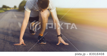 A young man trains and runs early in the morning. 83916408