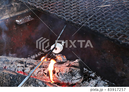 Cooking a marshmallow with a two prong thong 83917257