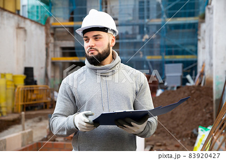 Engineer planning renovation works at building site 83920427