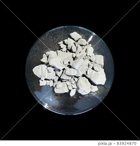 Aluminium powder in Chemical Watch Glass. Close up chemical ingredient on black table. Top View 83924870