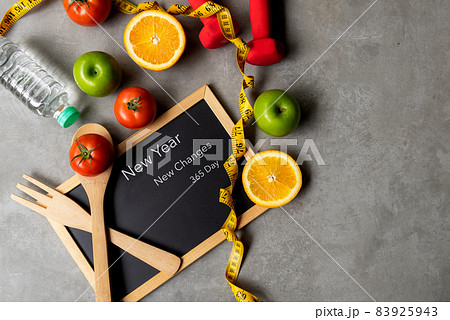 New Year for New Changes Healthy 2022. Fresh vegetable fruits and healthy food for sport equipment New Year for New Changes Healthy 2022. Fresh vegetable fruits and healthy food for sport equipment 83925943