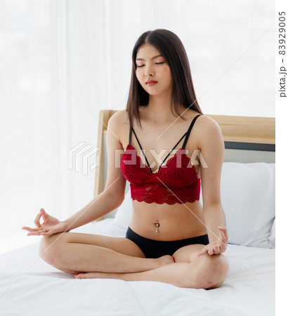 Beautiful young naughty sexy girl with romantic underwear cross-legged sit on white bed for meditation and calm down her mind in bright morning of rest day Beautiful young naughty sexy girl with romantic underwear cross-legged sit on white bed for meditation and calm down her mind in bright morning of rest day 83929005