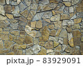 Wall of stone lined with brown limestone. 83929091