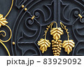 Decorative gilded elements of forged metal fence. 83929092
