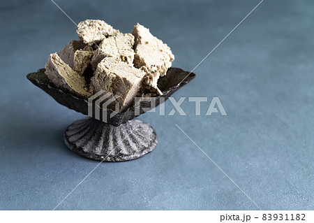 halva from sunflower seeds on a plate. national traditional sweetness of turkish halva on gray background halva from sunflower seeds on a plate. national traditional sweetness of turkish halva on gray background 83931182