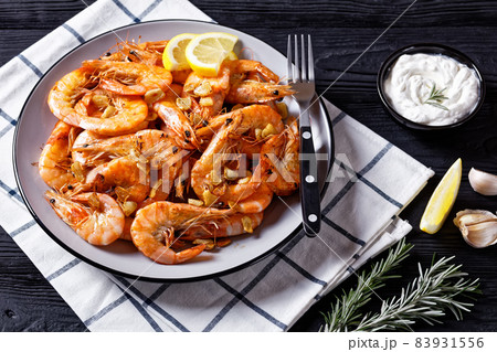 Grilled garlic butter prawns on a plate 83931556