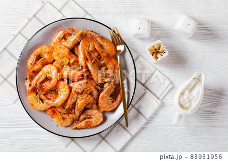 Grilled garlic butter prawns on a plate 83931956