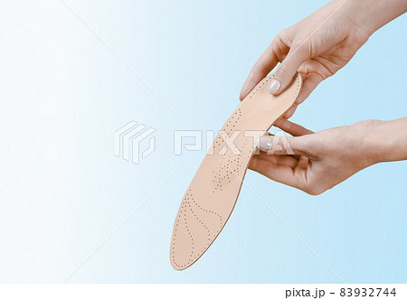 Orthopedic insole isolated on a blue background. Medical insoles. Treatment and prevention of flat feet and foot diseases. Foot care, feet comfort. Wear comfortable shoes. Flat Feet Correction. 83932744