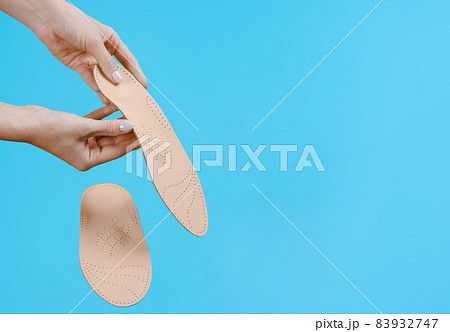 Orthopedic insole isolated on a blue background. Medical insoles. Treatment and prevention of flat feet and foot diseases. Foot care, feet comfort. Wear comfortable shoes. Flat Feet Correction. Orthopedic insole isolated on a blue background. Medical insoles. Treatment and prevention of flat feet and foot diseases. Foot care, feet comfort. Wear comfortable shoes. Flat Feet Correction. 83932747