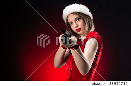 a girl in a red bodysuit and a Santa Claus hat with a shotgun in her hands for Christmas 83932755