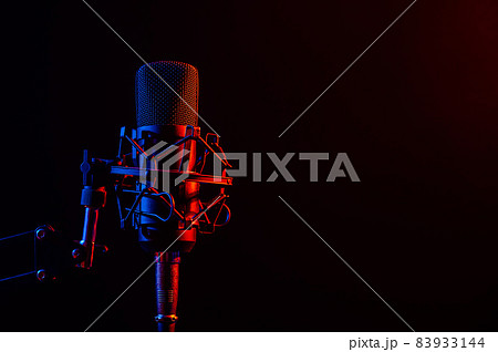 Professional microphone in pink smoke on a black background. Professional microphone in pink smoke on a black background. 83933144