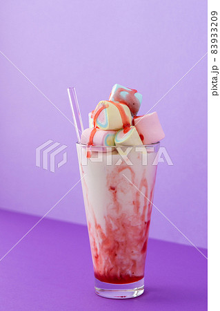 Milkshake with fruit syrup and multicolored marshmallows 83933209