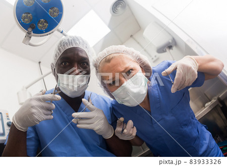 Patient from the operating table view of the surgical and assistant. Patient from the operating table view of the surgical and assistant. 83933326