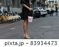 Milan, Italy - September 25, 2021:  Street style outfit, woman wearing a fashionable outfit on the streets of Milan, Italy. 83934473