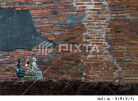 Three small buddha statue and wall made by old red brick background at Wat Ratchaburana. Three small buddha statue and wall made by old red brick background at Wat Ratchaburana. 83935045