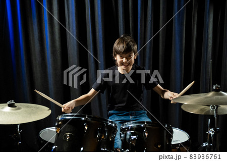 A boy plays drums in a recording studio A boy plays drums in a recording studio 83936761