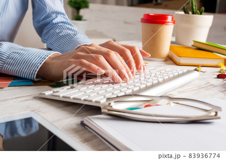 Woman consultant typing on keyboard Woman consultant typing on keyboard 83936774