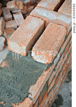 JASIN, MALAYSIA -SEPTEMBER 09, 2016: Clay brick walling joint and workmanship. Clay brick was attached together using cement mortar.    83936989