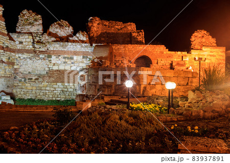 Ancient fortress wall at the entrance of the old town of Nessebar in Bulgaria at night 83937891