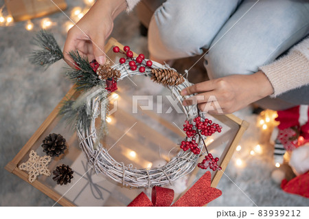 Woman with gift and present for Christmas and New Year party at home. 83939212