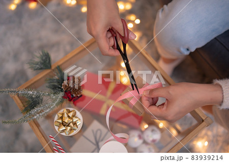 Woman with gift and present for Christmas and New Year party at home. Woman with gift and present for Christmas and New Year party at home. 83939214