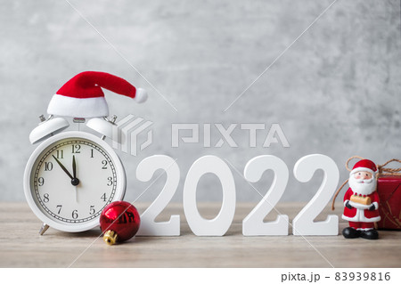 Merry Christmas with Vintage alarm clock and 2022 number on wooden table. Happy new Year, party, holiday and boxing day concept Merry Christmas with Vintage alarm clock and 2022 number on wooden table. Happy new Year, party, holiday and boxing day concept 83939816