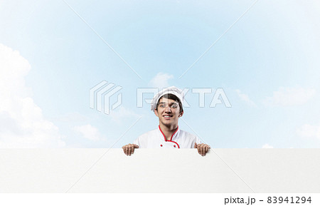 Young male chef with blank signboard Young male chef with blank signboard 83941294