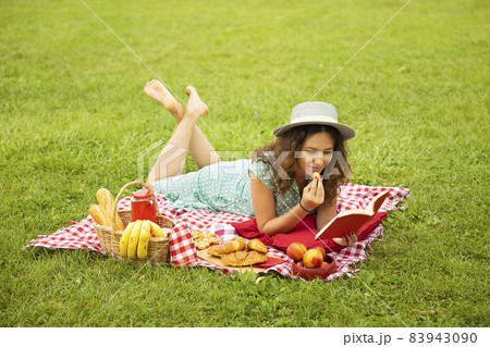Young woman reading a book in the park. Young woman reading a book in the park. 83943090