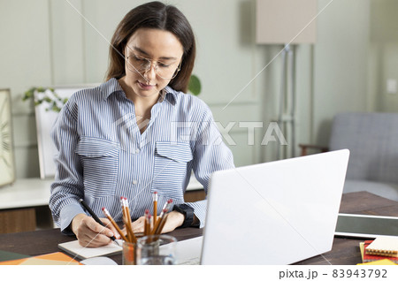 Businesswoman working with laptop at home 83943792