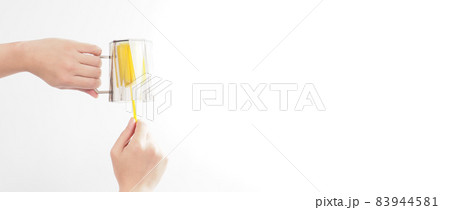 Clean and wash dish concept. Man hand washing drink glass on white background. Used drinking glass cleaning by soft yellow sponge stick. Wash cup by sponge brush. Disinfection hyginic in covid 19 era Clean and wash dish concept. Man hand washing drink glass on white background. Used drinking glass cleaning by soft yellow sponge stick. Wash cup by sponge brush. Disinfection hyginic in covid 19 era 83944581