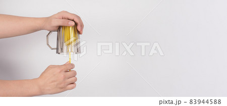 Clean and wash dish concept. Man hand washing drink glass on white background. Used drinking glass cleaning by soft yellow sponge stick. Wash cup by sponge brush. Disinfection hyginic in covid 19 era Clean and wash dish concept. Man hand washing drink glass on white background. Used drinking glass cleaning by soft yellow sponge stick. Wash cup by sponge brush. Disinfection hyginic in covid 19 era 83944588